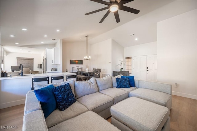 2548 Tumble Brook Dr, Las Vegas, NV 89134 - living room with ceiling fan, light wood finished floors, a chandelier, recessed lighting, and vaulted ceiling