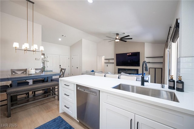 2548 Tumble Brook Dr, Las Vegas, NV 89134 - kitchen with dishwasher, vaulted ceiling, light countertops, white cabinetry, and a ceiling fan