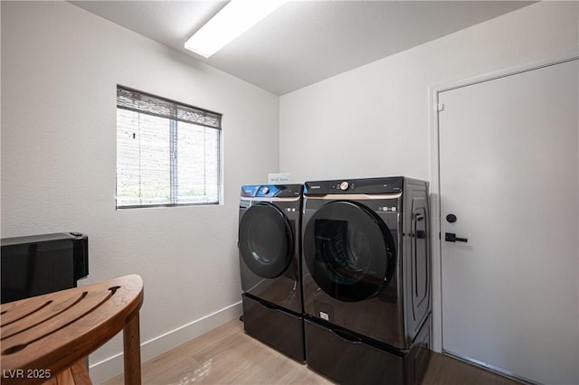 2548 Tumble Brook Dr, Las Vegas, NV 89134 - washroom with washing machine and dryer and light wood-style floors