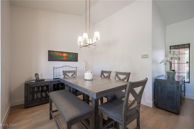 2548 Tumble Brook Dr, Las Vegas, NV 89134 - dining area with light wood-style floors, a chandelier, and high vaulted ceiling