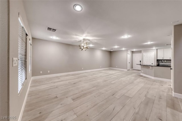 2337 Via Barranca St, Henderson, NV 89044 - unfurnished living room with light wood finished floors and baseboards