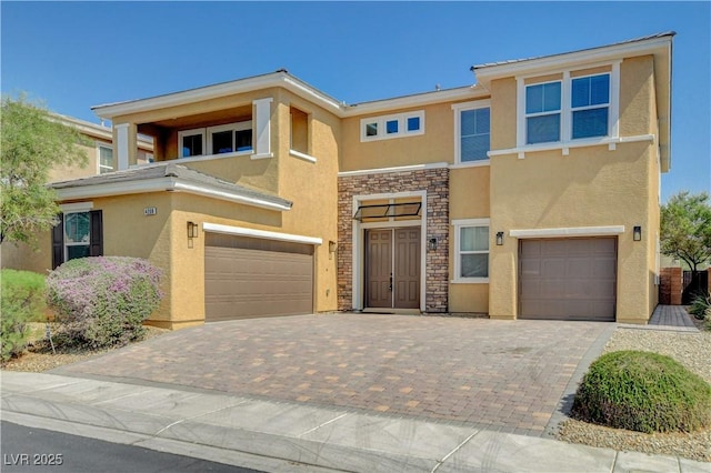 4208 Falcons Flight Ave, North Las Vegas, NV 89084 - view of front of property featuring a garage, stucco siding, stone siding, and decorative driveway