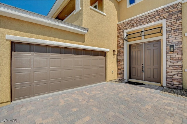 4208 Falcons Flight Ave, North Las Vegas, NV 89084 - view of exterior entry with stucco siding, stone siding, and driveway