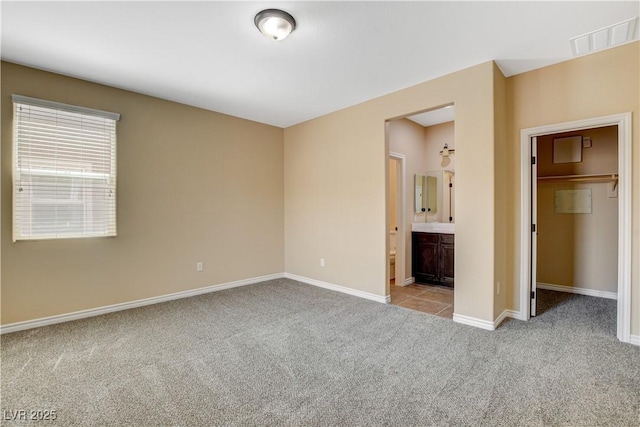 4208 Falcons Flight Ave, North Las Vegas, NV 89084 - unfurnished bedroom featuring carpet floors, a walk in closet, and ensuite bath