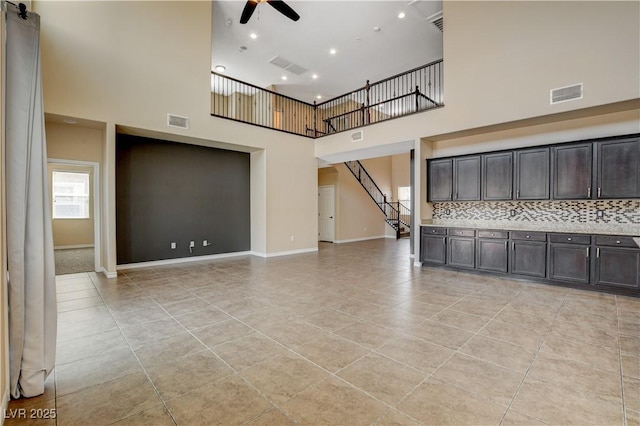 4208 Falcons Flight Ave, North Las Vegas, NV 89084 - unfurnished living room featuring a ceiling fan, a towering ceiling, light tile patterned flooring, stairs, and recessed lighting