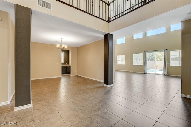 4208 Falcons Flight Ave, North Las Vegas, NV 89084 - unfurnished living room featuring a chandelier, a towering ceiling, and tile patterned flooring