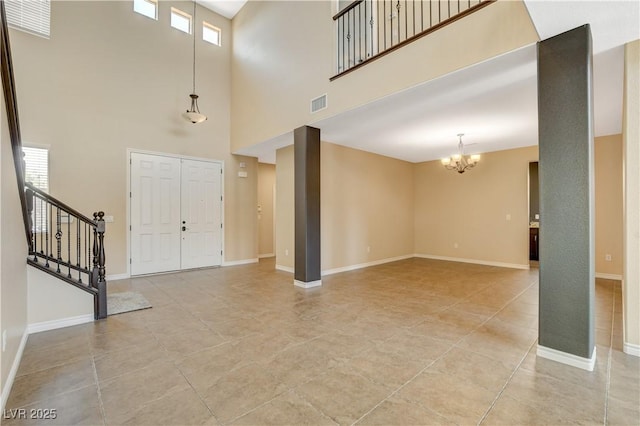4208 Falcons Flight Ave, North Las Vegas, NV 89084 - entrance foyer with a chandelier, a towering ceiling, stairway, and light tile patterned floors