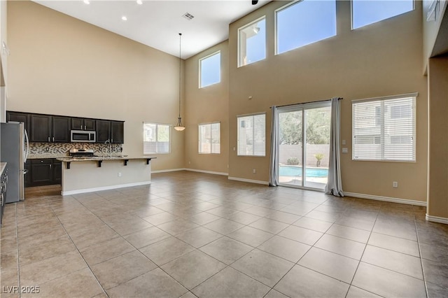 4208 Falcons Flight Ave, North Las Vegas, NV 89084 - unfurnished living room with a towering ceiling and light tile patterned floors