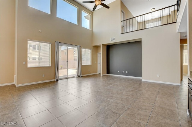 4208 Falcons Flight Ave, North Las Vegas, NV 89084 - unfurnished living room featuring ceiling fan, a high ceiling, and light tile patterned flooring