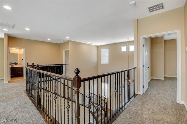 4208 Falcons Flight Ave, North Las Vegas, NV 89084 - hallway with light carpet, recessed lighting, and an upstairs landing