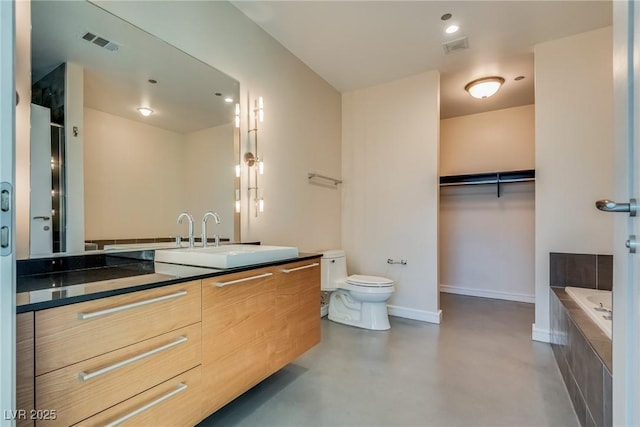 200 Hoover Ave Unit 903, Las Vegas, NV 89101 - full bathroom with double vanity, finished concrete floors, a garden tub, and a walk in closet