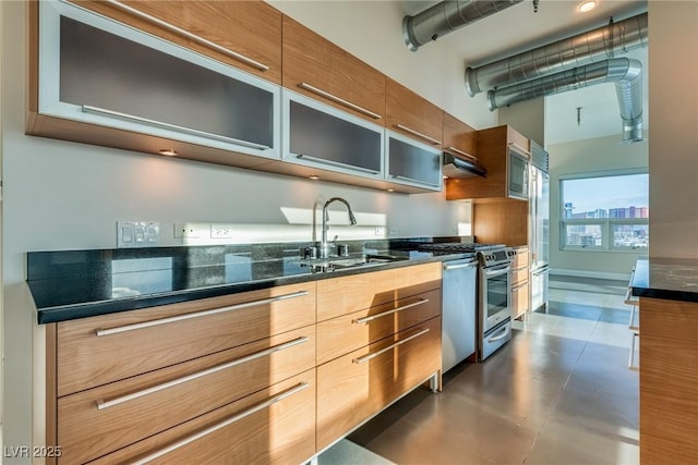200 Hoover Ave Unit 903, Las Vegas, NV 89101 - kitchen with modern cabinets, glass insert cabinets, stainless steel appliances, brown cabinetry, and a towering ceiling
