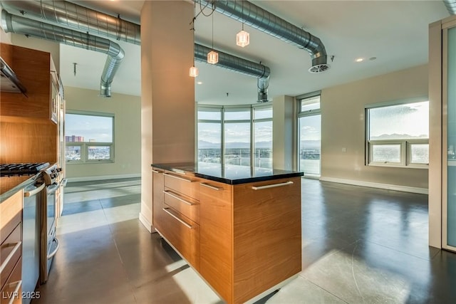 200 Hoover Ave Unit 903, Las Vegas, NV 89101 - kitchen featuring stainless steel gas stove, finished concrete flooring, dark countertops, modern cabinets, and brown cabinets