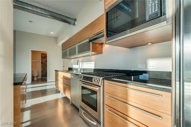 200 Hoover Ave Unit 903, Las Vegas, NV 89101 - kitchen featuring stainless steel appliances, range hood, brown cabinetry, and modern cabinets