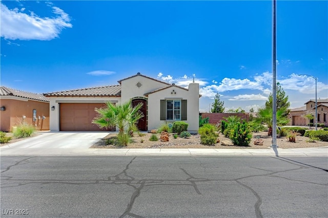 3605 Greenbriar Bluff Ave, North Las Vegas, NV 89081 - mediterranean / spanish home with stucco siding, an attached garage, concrete driveway, and a tiled roof