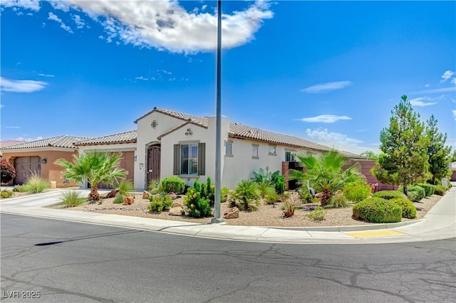 3605 Greenbriar Bluff Ave, North Las Vegas, NV 89081 - mediterranean / spanish home with a tiled roof, an attached garage, stucco siding, and concrete driveway