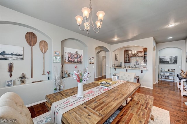 3605 Greenbriar Bluff Ave, North Las Vegas, NV 89081 - dining area featuring a chandelier, arched walkways, and wood finished floors