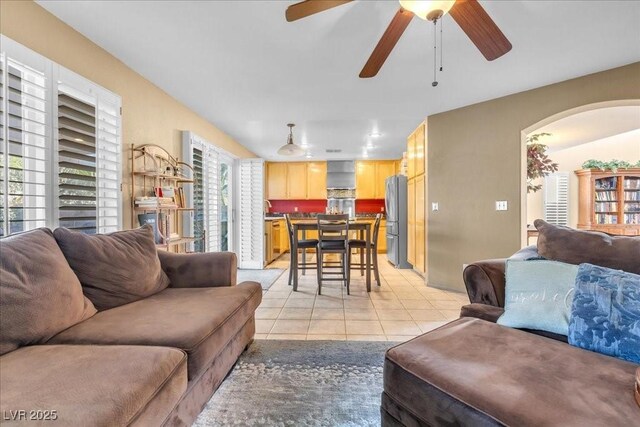 9836 La Vid Ct, Las Vegas, NV 89117 - living area featuring light tile patterned floors, arched walkways, and ceiling fan