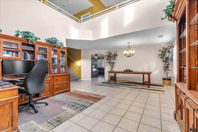 9836 La Vid Ct, Las Vegas, NV 89117 - home office with light tile patterned flooring, a high ceiling, a chandelier, and arched walkways