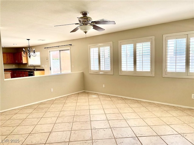 164 Swale Ln, Las Vegas, NV 89144 - spare room featuring a ceiling fan, a chandelier, and light tile patterned floors