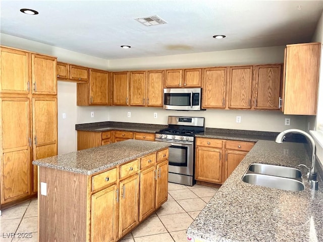 164 Swale Ln, Las Vegas, NV 89144 - kitchen featuring stainless steel appliances, light tile patterned floors, a center island, dark stone countertops, and recessed lighting