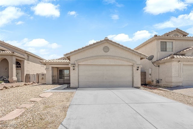 1205 Boulder Shore Ave, North Las Vegas, NV 89081 - view of front of house featuring an attached garage, concrete driveway, stucco siding, and a tiled roof