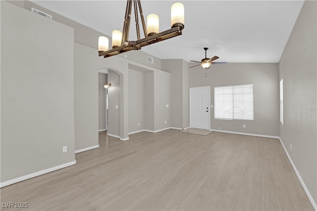 1205 Boulder Shore Ave, North Las Vegas, NV 89081 - spare room featuring arched walkways, ceiling fan, and light wood-style floors