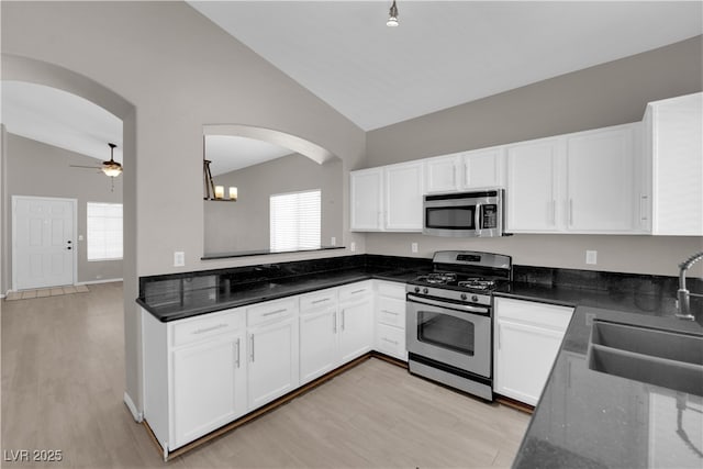 1205 Boulder Shore Ave, North Las Vegas, NV 89081 - kitchen featuring stainless steel appliances, arched walkways, healthy amount of natural light, and high vaulted ceiling