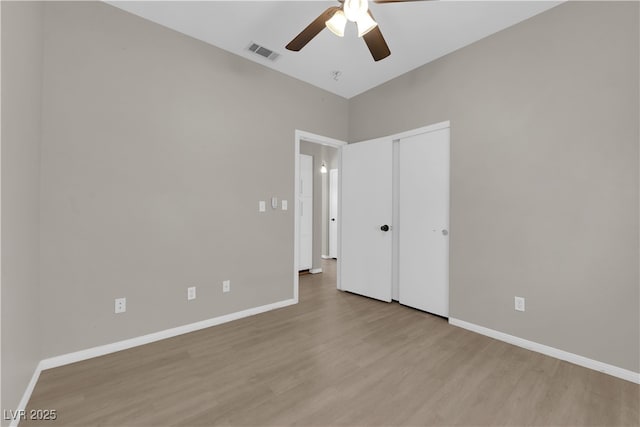 1205 Boulder Shore Ave, North Las Vegas, NV 89081 - unfurnished bedroom with wood finished floors, a closet, and a ceiling fan