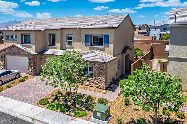 7009 Judith River St, North Las Vegas, NV 89084 - view of front of home with stucco siding, decorative driveway, and a tile roof