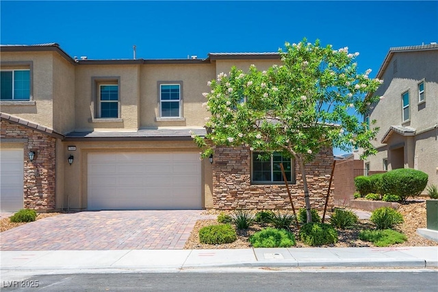 7009 Judith River St, North Las Vegas, NV 89084 - view of front of property with stone siding, stucco siding, a garage, and decorative driveway
