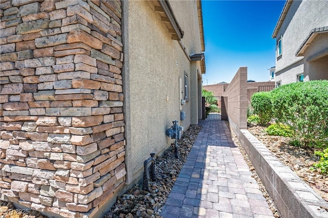 7009 Judith River St, North Las Vegas, NV 89084 - view of home's exterior with stucco siding and a gate