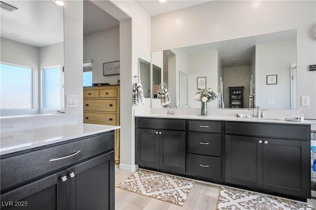 7009 Judith River St, North Las Vegas, NV 89084 - bathroom with double vanity and wood finished floors