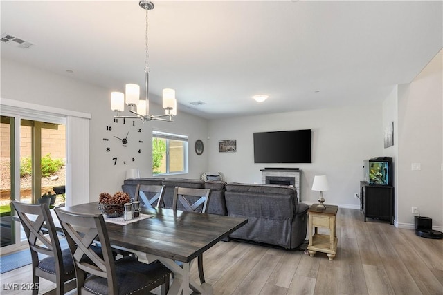 7009 Judith River St, North Las Vegas, NV 89084 - dining space with light wood finished floors and a chandelier