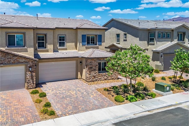 7009 Judith River St, North Las Vegas, NV 89084 - view of front of home featuring an attached garage, a tile roof, and stucco siding
