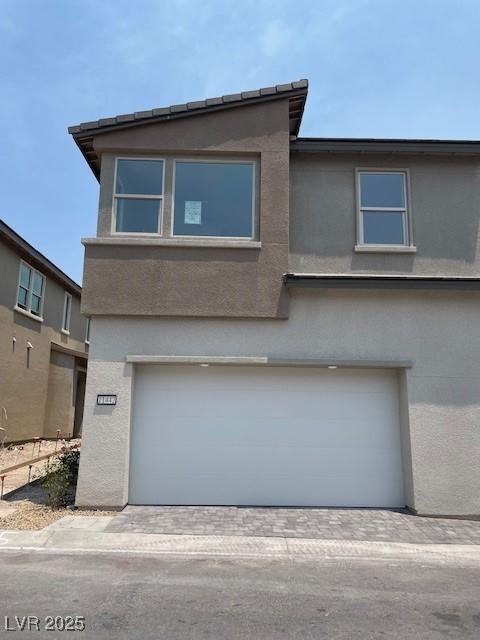 11442 Crimson Ledge Ave, Las Vegas, NV 89138 - view of front of property with an attached garage and stucco siding
