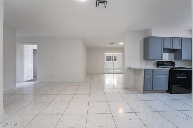 5317 Lytton Ave, Las Vegas, NV 89146 - kitchen featuring black / electric stove, light countertops, light marble finish flooring, and open floor plan