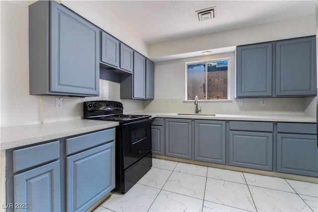 5317 Lytton Ave, Las Vegas, NV 89146 - kitchen with black electric range, light marble finish floors, light countertops, and blue cabinets
