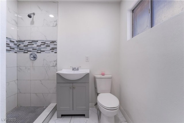5317 Lytton Ave, Las Vegas, NV 89146 - bathroom with marble look tiles, a tile shower, and vanity