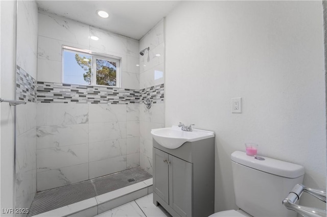 5317 Lytton Ave, Las Vegas, NV 89146 - bathroom featuring marble look tile flooring, tiled shower, and vanity