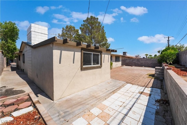 5317 Lytton Ave, Las Vegas, NV 89146 - back of house featuring a fenced backyard, a patio area, and stucco siding