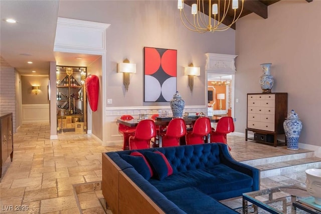 2030 Mohigan Way, Las Vegas, NV 89169 - living area with stone tile flooring, a high ceiling, a chandelier, a wainscoted wall, and recessed lighting