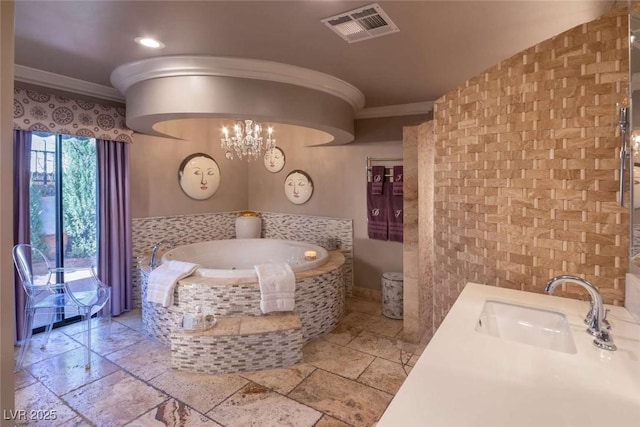 2030 Mohigan Way, Las Vegas, NV 89169 - bathroom featuring ornamental molding, a garden tub, stone tile flooring, a chandelier, and vanity