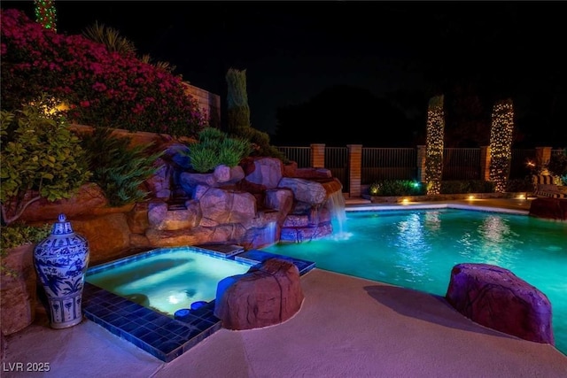 2030 Mohigan Way, Las Vegas, NV 89169 - pool at night featuring a pool with connected hot tub