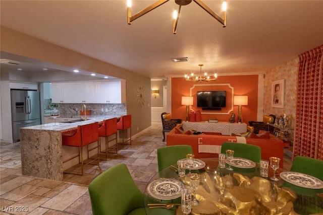 2030 Mohigan Way, Las Vegas, NV 89169 - dining room featuring a chandelier and stone tile flooring