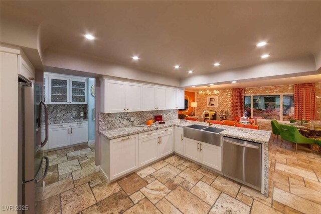 2030 Mohigan Way, Las Vegas, NV 89169 - kitchen featuring stainless steel appliances, recessed lighting, backsplash, open floor plan, and stone tile floors