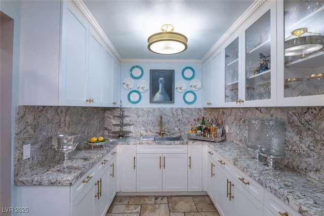 2030 Mohigan Way, Las Vegas, NV 89169 - kitchen featuring white cabinetry, tasteful backsplash, and crown molding