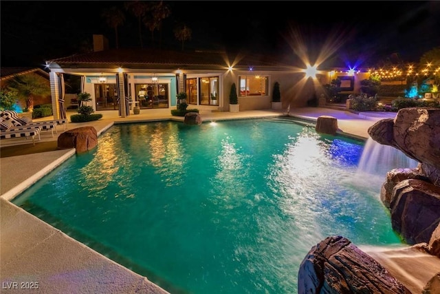 2030 Mohigan Way, Las Vegas, NV 89169 - pool at night with an outdoor pool and a patio