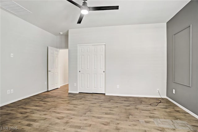 7546 Cooks Meadow St, North Las Vegas, NV 89084 - unfurnished bedroom with wood finished floors, ceiling fan, and a closet