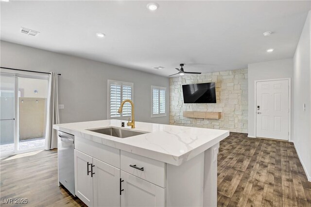7546 Cooks Meadow St, North Las Vegas, NV 89084 - kitchen with a ceiling fan, wood finished floors, stainless steel dishwasher, white cabinetry, and a center island with sink
